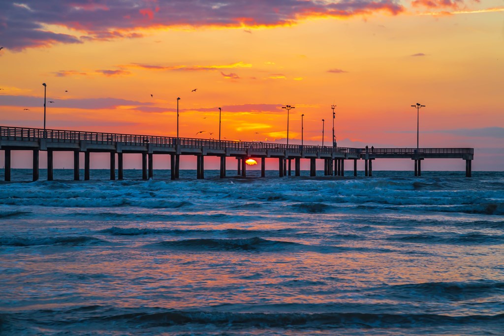Sun setting over Port Aransas pier on Texas Gulf Coast
